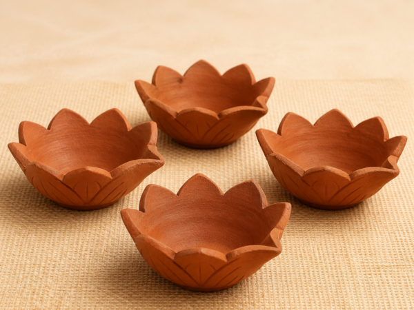 Handcrafted Terracotta Lotus Diyas – Hero Set of four handcrafted terracotta lotus diyas on a natural jute surface